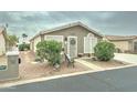 Lovely front exterior showcasing a well-maintained yard with mature plants and a cozy front porch at 2101 S Meridian Rd # 99, Apache Junction, AZ 85120
