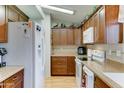 Well-lit kitchen featuring wooden cabinets, modern appliances, and laminate countertops at 2101 S Meridian Rd # 99, Apache Junction, AZ 85120