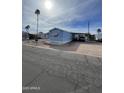 Charming blue mobile home with awning, carport and low maintenance landscaping at 2121 N Center St # 141, Mesa, AZ 85201