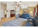 Spacious living room with wood floors, a ceiling fan, and neutral wall colors at 2123 E Catclaw St, Gilbert, AZ 85296