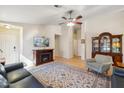 Inviting living room features a fireplace, ceiling fan, and wood flooring at 2123 E Catclaw St, Gilbert, AZ 85296