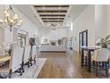 Spacious living room featuring high ceilings with wooden beams, a fireplace, and hardwood floors at 2285 E Chandler Heights Rd, Chandler, AZ 85249