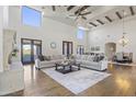 Comfortable living room with large windows, a stone fireplace, hardwood floors, and a stylish rug at 2285 E Chandler Heights Rd, Chandler, AZ 85249