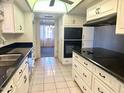 Spacious kitchen featuring white cabinets and black appliances at 236 E Minton Dr, Tempe, AZ 85282