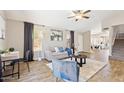 Cozy living room featuring wood floors, neutral decor, and bright natural lighting at 2916 E Amber Ridge Way, Phoenix, AZ 85048
