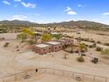 Aerial view of a Southwestern-style home with desert landscaping, horse property and mountain views at 29204 N Bryce Trl, Queen Creek, AZ 85144