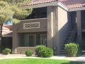 Two-story condo exterior featuring private patios, desert landscaping, and convenient stair access to upper levels at 2929 W Yorkshire Dr # 2118, Phoenix, AZ 85027