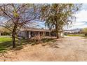 Landscaped home exterior with a covered porch and spacious front yard at 3137 W Baseline Rd, Laveen, AZ 85339