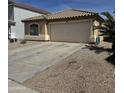 Single story home featuring low maintenance landscaping, a tile roof, and an attached two-car garage at 37959 N Luke Ln, San Tan Valley, AZ 85140