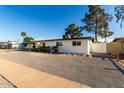 Single story home with low maintenance landscaping, a carport and a white exterior at 4147 W Cheery Lynn Rd, Phoenix, AZ 85019