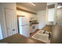 Well-lit kitchen with white appliances, cabinets, and a double-basin sink at 435 W Rio Salado Pkwy # 210, Tempe, AZ 85281