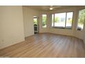 Bright living room featuring wood floors, ceiling fan, large windows, and balcony access at 435 W Rio Salado Pkwy # 210, Tempe, AZ 85281