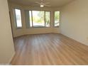 Bright living room featuring wood floors, ceiling fan, large windows, and balcony access at 435 W Rio Salado Pkwy # 210, Tempe, AZ 85281