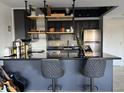 Kitchen island with bar seating, stainless steel appliances, and modern cabinets at 4750 N Central Ave # 1N, Phoenix, AZ 85012