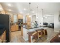 Well-lit kitchen featuring wooden cabinets, a sleek black countertop island, and modern appliances at 5100 E Rancho Paloma E Dr # 1046, Cave Creek, AZ 85331
