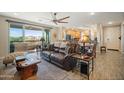 Bright living room with a comfortable brown leather couch and sliding doors leading to a balcony at 5100 E Rancho Paloma E Dr # 1046, Cave Creek, AZ 85331