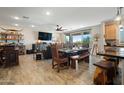 Bright, open-concept living space with stylish wood-look tile flooring and a modern kitchen viewable in the background at 5100 E Rancho Paloma E Dr # 1046, Cave Creek, AZ 85331