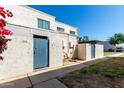 Charming two-story home with blue door and freshly landscaped front yard, and desert landscaping at 5254 N 42Nd Pkwy, Phoenix, AZ 85019