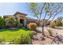 Inviting single-story home with a well-manicured lawn and mature desert landscaping at 581 W Angus Rd, San Tan Valley, AZ 85143