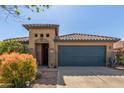 Charming single-story home with a two-car garage and mature desert landscaping at 581 W Angus Rd, San Tan Valley, AZ 85143