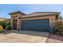 Charming single-story home with a two-car garage and mature desert landscaping at 581 W Angus Rd, San Tan Valley, AZ 85143