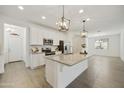 Open-concept kitchen features a spacious island, white cabinetry, and modern appliances at 5854 S Del Rancho --, Mesa, AZ 85212