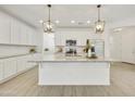 Bright kitchen with a large island, white cabinets, and stainless steel appliances at 5854 S Del Rancho --, Mesa, AZ 85212