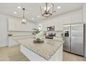Modern kitchen features a large island, granite countertops, and stainless steel appliances at 5854 S Del Rancho --, Mesa, AZ 85212