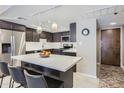 Modern kitchen featuring sleek countertops, stainless steel appliances, and a breakfast bar with seating at 7960 E Camelback Rd # 209, Scottsdale, AZ 85251