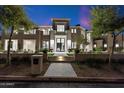 Stunning home with a meticulously landscaped front yard and walkway, offering a glimpse of its grand design at 9735 E Kemper Way, Scottsdale, AZ 85255