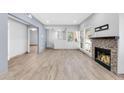 Bright living room featuring modern tile flooring, a stylish fireplace, and ample natural light at 101 N 7Th St # 210, Phoenix, AZ 85034