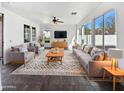 Bright living room with large windows, plush seating, and stylish decor at 10418 E Nopal Ave, Mesa, AZ 85209