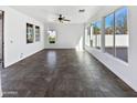 Open-concept living area with tile flooring, lots of light, and views to the outdoors at 10418 E Nopal Ave, Mesa, AZ 85209