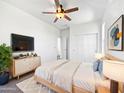 Comfortable main bedroom with ceiling fan, closet, and decorative furnishing at 10418 E Nopal Ave, Mesa, AZ 85209