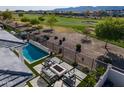 An inviting backyard with a pool, fire pit, and views of the golf course at 11344 N San Clemente St, Surprise, AZ 85388