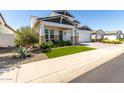 Charming two story home with a three car garage, manicured lawn and desert landscaping at 11344 N San Clemente St, Surprise, AZ 85388