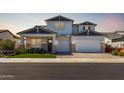 Stunning two-story home with a three car garage and a well manicured lawn at 11344 N San Clemente St, Surprise, AZ 85388