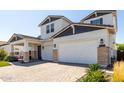 Beautiful two story home with a three car garage and brick paver driveway at 11344 N San Clemente St, Surprise, AZ 85388