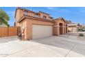 View of the side of the home featuring a spacious driveway and a neutral-colored exterior at 1343 E Walnut Rd, Gilbert, AZ 85298