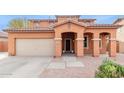 Charming two-story home with a neutral-colored exterior, tile roof, and well-manicured front yard at 1343 E Walnut Rd, Gilbert, AZ 85298