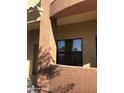 Exterior detail showcasing stucco and window, with sunlight and shadow play at 16216 N 30Th Pl, Phoenix, AZ 85032