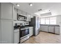 Updated kitchen featuring stainless steel appliances, sleek countertops, and modern cabinetry at 2605 N Pleasant Dr, Chandler, AZ 85225