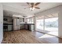 Bright kitchen with stainless steel appliances, grey cabinets and hardwood flooring, with views of the pool at 2605 N Pleasant Dr, Chandler, AZ 85225