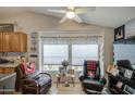 Cozy living room featuring vaulted ceilings, ceiling fan and sitting area with two recliners at 3104 E Broadway Rd # 212, Mesa, AZ 85204