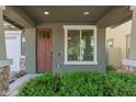 A welcoming front entrance with a solid door, sidelight window, and manicured shrubbery at 4059 E Mesquite St, Gilbert, AZ 85296