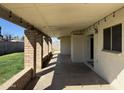 A covered back porch with brick pillars and string lights overlooks a private backyard at 409 W Ross Ave, Phoenix, AZ 85027