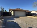 A single-story home features a two-car garage and xeriscaped front yard in a neighborhood at 409 W Ross Ave, Phoenix, AZ 85027