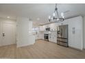 Bright, modern kitchen featuring stainless steel appliances, white cabinets, and sleek countertops at 4646 E Contessa St, Mesa, AZ 85205