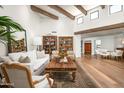 Bright living room with wood floors, exposed beams, and comfortable, elegant furnishings at 5101 N Casa Blanca Dr # 217, Paradise Valley, AZ 85253