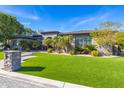 Stunning home showcasing lush green lawn and desert landscaping, a true paradise at 7150 E Balfour Rd, Paradise Valley, AZ 85253